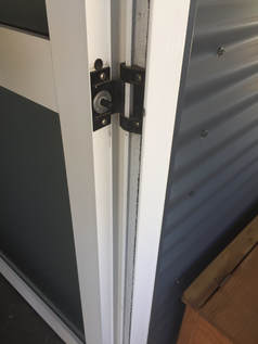SoftSlam installed in an aluminum door to prevent door slamming